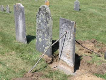 A stone in Kenniston Cemetery is cemented back into place. Courtesy of Merlin Gray