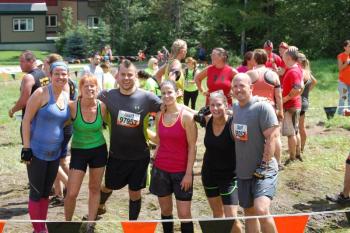 Looking a little wearier but undaunted local teammates pose with another participant at the end. Courtesy of John Mitkus 