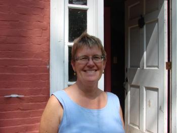 Stephenson is all smiles outside the Salt Marsh School she and husband Tom Blackford bought in early August. SUSAN JOHNS/Wiscasset Newspaper
