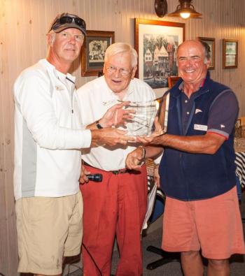 Ken Colburn, left, winner of the Division One series in the Boothbay Harbor Yacht Club Regatta sailing his Swan 42, Apparition. Colburn is being congratulated by BHYC Commodore  Neil Newton (right) and PC Andy Holmes, Regatta chair. Courtesy of Don Snyder