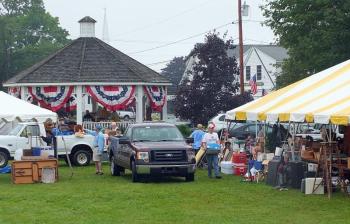 Rotarians load items for Saturday's auction and flea market under the tents at the Boothbay Common August 2. GARY DOW/Boothbay Register