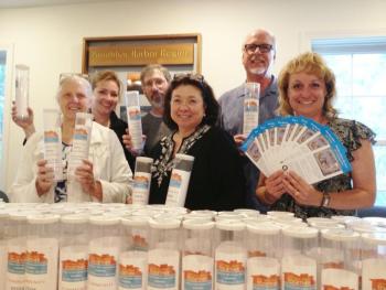 The Getting Away Committee displaying its colorful donation cans and fliers. Pictured from left, Melba Gunnison, Jane Dow, Jason Sheckley, Audrey Miller, Gardiner Rapelye Jr. and Catherine Wygant Fossett. RYAN LEIGHTON/ Boothbay Register 