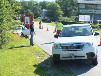 Frederick Fahlsing looks over the damage to his Subaru after he was rear ended by Michael Andretta on August 1. RYAN LEIGHTON/ Boothbay Register