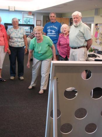 Cam Johnson is up “at bat,” in a beanbag-toss version of baseball following an August 7 supper at the senior center in Wiscasset. SUSAN JOHNS/Wiscasset Newspaper
