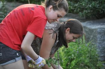 Morganne Elkins and Mackenzie Colby working on the church gardens. Courtesy of Deanne Tibbetts
