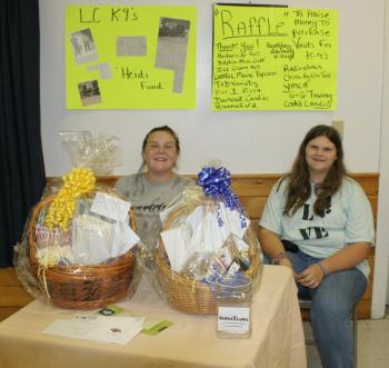 Chelsea Graves, left, and Tabetha Harrington are in charge of selling raffle tickets to benefit the Lincoln County K-9 program at the Hometown Heroes event. KEVIN BURNHAM/Boothbay Register 