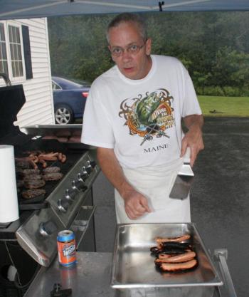 Rotary chef Kim Mills finishes another batch of grilled hot dogs. KEVIN BURNHAM/Boothbay Register