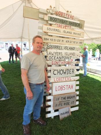 Ed Phelps sells his rustic local signs, made from reused fence posts and old oars. RYAN LEIGHTON/Boothbay Register