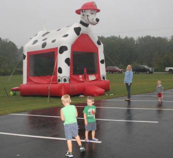 Despite the light rain, kids still enjoyed the bouncy house outside of the Legion Hall. KEVIN BURNHAM/Boothbay Register 