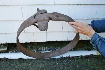 A photo of the mastband that was found on Damariscove. The tightening mechanism is at top; part of the spike that was driven into the mast is on the left. The hole shows where the other spike was. KEVIN BURNHAM/Boothbay Register