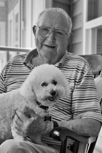 St. Andrews Village resident Don Walker’s Bichon Mandy not only makes sure he gets plenty of exercise, she brightens his day and facilitates many conversations on their walks. Courtesy of Alan Crowell