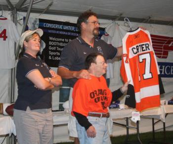 Tom and Bonnie Erskine auction off a jersey with the late Special Olympian Howard Gordon for the Boothbay Charities Classic in 2011. Courtesy of John Edwards
