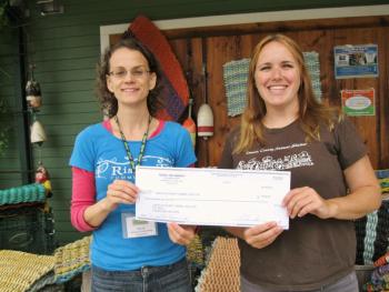 Lincoln County Animal Shelter receives a $300 donation as the July recipient. Elya Markert, Rising Tide Outreach Coordinator, left, presents the check to Carrie Koskela, Lincoln County Animal Shelter office manager. Courtesy of Rising Tide