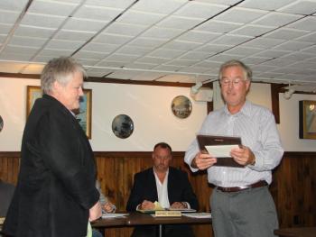 Marge Kilkelly, left, of Dresden looks on as Maine Yankee spokesman Eric Howes reads a plaque honoring Kilkelly's service with the Maine Yankee Community Advisory Panel. Seated nearby is Maine Yankee's chief nuclear officer Wayne Norton. SUSAN JOHNS/Wiscasset Newspaper