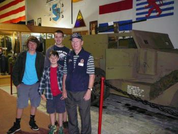 World War II veteran and museum volunteer Austin Carter provides a tour of the Cole Transportation Museum to Southport Scouts Jake Brewer, left, Liam Cullina, middle, and Jacob Bishopp, back. Courtesy of Sarah Sherman World War II veteran and museum volunteer Austin Carter provides a tour of the Cole Transportation Museum to Southport Scouts Jake Brewer (left), Liam Cullina (middle) and Jacob Bishopp (back). Courtesy of Sarah Sherman