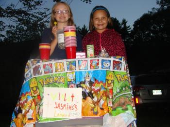 On a brisk Friday night in Alna September 6, two Wiscasset Primary students and best friends, Violet Wilson-Wood, left, and Jasmine Rego sell  iced tea on Route 218 to raise money to save St. Andrews Hospital. Rego's dad Mark Rego was born there. SUSAN JOHNS/Wiscasset Newspaper