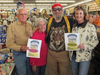 Big Al Cohen hands out contest gift certificates to Mark Powley and his wife and Linda Campbell, right. 