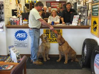 Hazen Smith accepts a gift certificate won by his daughter Megan at Hawke Motors, featuring mascots Perry and Peter Hawke. 