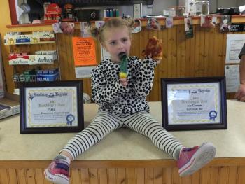 Addie Barter, daughter of Ice Cream Hut owner Katrina Dunsmore, poses with the Boothbay’s best ice cream award. 