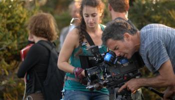 JOE ARCIDIACONO, director of photography, on the cliffs of Monhegan with assistant Olivia. Courtesy of Thomas Hurd, Catatonk Blues