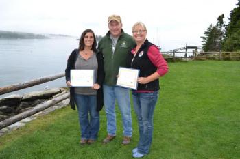 Maine Department of Marine Resources Commissioner Patrick Keliher (center) stands with DMR Manager of the Year, Alison Sirois, a DMR Scientist III (left), and Employee of the Year, Cathy Fetterman, DMR Licensing Manager (right), after each received an award during the department’s annual meeting in September. The Manager of the Year Award was presented to Sirois for overseeing water quality and safety along the entire coastline for the Bureau of Public Healthy. Fetterman received the employee of the year fo