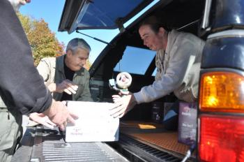 DENNIS BLACKMAN, left, Lou Scala and Blaisette Gauthier load boxes of food into a truck on October 18 at Hannaford's in Boothbay Harbor. The Boothbay Region Fish & Game Association donated 30 boxes of food to the Boothbay Region Food Pantry. BEN BULKELEY/Boothbay Register