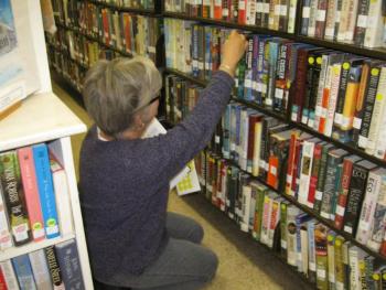 Boothbay Harbor Memorial Library Trustee Lee Hammond helps mark books to be transferred to the temporary location at the Meadow Mall. Photo Courtesy of Tim McFadden