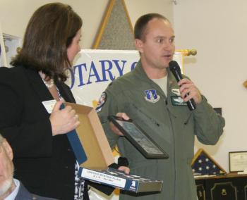 Lt. Col. Tyler Blake of the Air National Guard presents a special flag and photograph to club president Jennifer Page Osman. KEVIN BURNHAM/Boothbay Register Lt. Col. Tyler Blake of the Air National Guard presents a special flag and photograph to club president Jennifer Page Osman. KEVIN BURNHAM/Boothbay Register