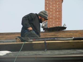 Photo of Josh Gallant of Augusta working on the roof of the 1811 jail in Wiscasset