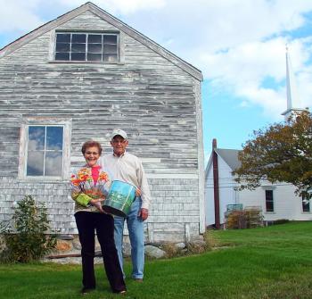 Faith and Joel Vittori hold the waste can behind Ernestine Dodge’s garage. SUZI THAYER/Boothbay Register