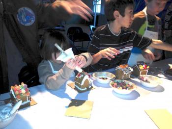 Kids try decorating a gingerbread house. MIKE MARR/Boothbay Register Kids