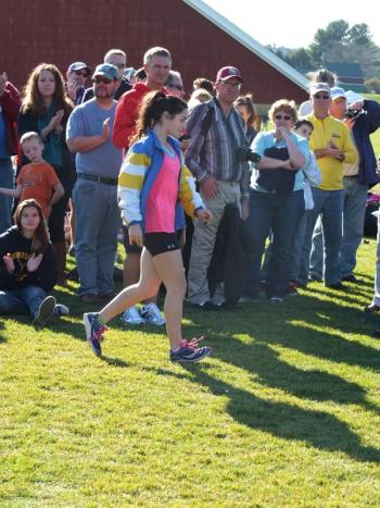 Senior Sophia Thayer walks up to the winner circle after finishing fourth place overall in the state championship race. RYAN LEIGHTON/Boothbay Register