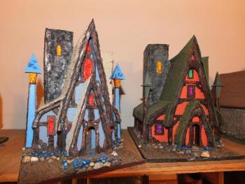 The many model houses Lee designs and builds as a hobby. The “Witches House” on the right is what Lee plans to build next. RYAN LEIGHTON/ Boothbay Register