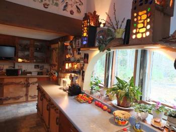 The colorful kitchen that includes cabinets hinges all hand carved. RYAN LEIGHTON/Boothbay Register