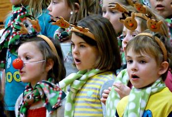 Three kindergarteners in the front row, including one dressed up like Rudolph. KATRINA CLARK/Boothbay Register