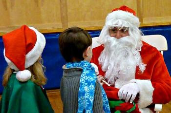 Who’s that mysterious visitor in red? The kids all were eager to say hello. KATRINA CLARK/Boothbay Register