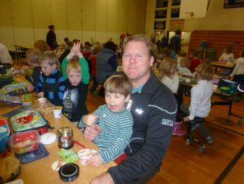 Casey Smith eats lunch while his son, Noah, munches on ice cream in the BRES cafeteria during Parent’s Day. KATRINA CLARK/Boothbay Register