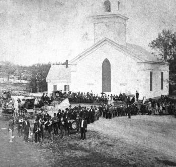 The 1848 Congregational Church on Townsend Avenue, as it appeared in 1880. Built by blacksmith-shipbuilder-hotel owner John Weymouth, the original roof was not as sharp as the present one, which was added in 1881. Having been in the upper part of the church, I know the older, massive, skeletal roof timbers are still in place. The 1880 crowd is on hand for Memorial Day. No doubt Charley's funeral 17 years earlier brought out a crowd many times the size of the 1880 one. Courtesy of the Boothbay Region Historical Society church
