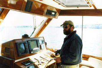 Captain Mark Colby piloting a yacht. Courtesy of Mark Colby