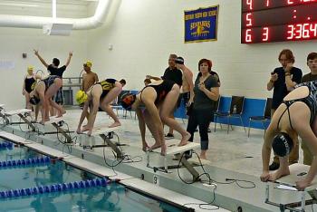 The girls get ready for the 200-yard IM. From left, Elise Dumont of Lincoln Academy, Nicole LaBrecque of Boothbay, Bethany Winkin of Winslow, and Holly Stegna of Lincoln Academy. KATRINA CLARK/Boothbay Register