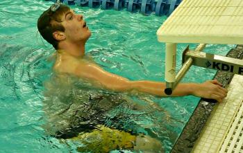Brad Tibbetts strains to see his time for the grueling 500-yard freestyle. He came in first place with a time of 5:57.45, 17.55 seconds faster than needed to qualify for state. KATRINA CLARK/Boothbay Register