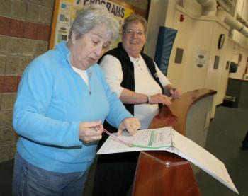 Bobbie Reed and Donna McLellan sign in for their walk at the YMCA on Tuesday, March 25. KEVIN BURNHAM/Boothbay Register