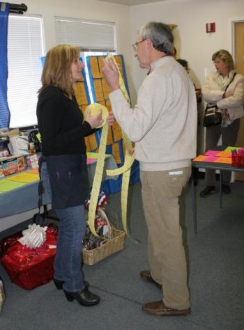 Penny Bryer Plummer sells some raffle tickets to Bob Boyd. KEVIN BURNHAM/Boothbay Register
