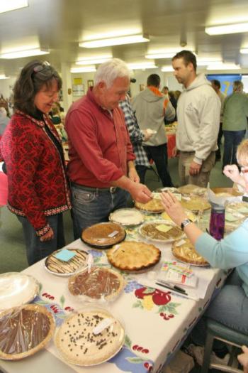 Jane and Dan Stevens make a purchase at the pie table. KEVIN BURNHAM/Boothbay Register