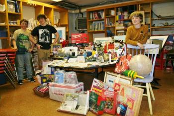Southport Central School sixth graders, from left, Clarence Burnham, Ryan Hughes and Julius Bennett, stand amongst the myriad items they and others have collected for the Winter Carnival auction and raffle, which will be held at the Southport Town Hall on Saturday, March 22. KEVIN BURNHAM/Boothbay Register