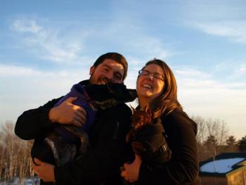 Laila, a mixed breed of Australian cattle dog and Boston terrier, in the arms of her forever dad Dalton Tibbetts. She gives a kiss to her forever mother Ashlea Andrews who’s holding Petey the miniature pincher. Photo By Bryson Williamson