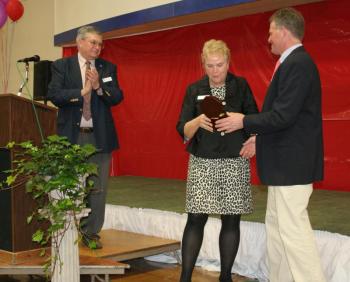 Peggy Pinkham, outgoing Y board president receives a gift from Y Executive Director Andy Hamblett. At left is incoming Y board president Wells Moore. KEVIN BURNHAM/Boothbay Register Pinkham
