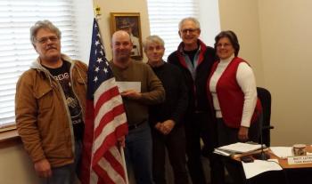 From left, Richard McFarland, Selectmen’s Chairman Joshua Pinkham, and selectmen David Atwater, Ronn Orenstein and Robin Mayer. The Damariscotta Board of Selectmen was recently presented with a $1,000 check for insurance from the American Legion to be able to hang American flags throughout downtown during the summer. BEN BULKELEY/Wiscasset Newspaper