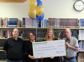 NORMAND L’HEUREUX, president of Boothbay Region Education Association, left, with Lois Kilby-Chesley, Maine Education Association’s president, and Amy Grosso of California Casualty, present a $1,500 grant to high school tennis coach and English teacher Mark Gorey. SUZI THAYER/Boothbay Register