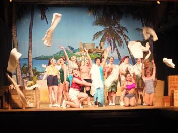 Devin Dukes, center, as Nellie Forbush of Little Rock, Arkansas, attempting to 'wash that man right outta her hair.' LISA KRISTOFF/Boothbay Register